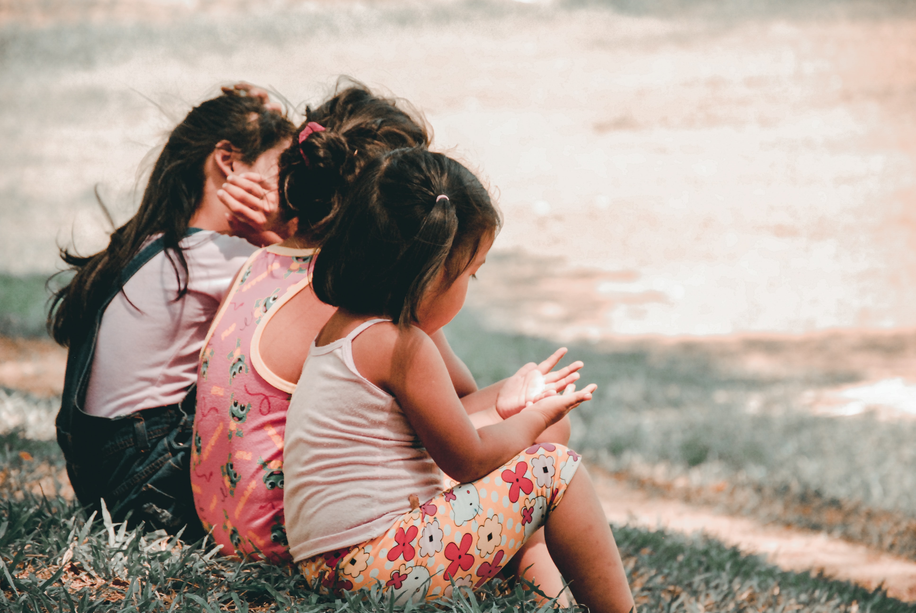 Three children on a hill.